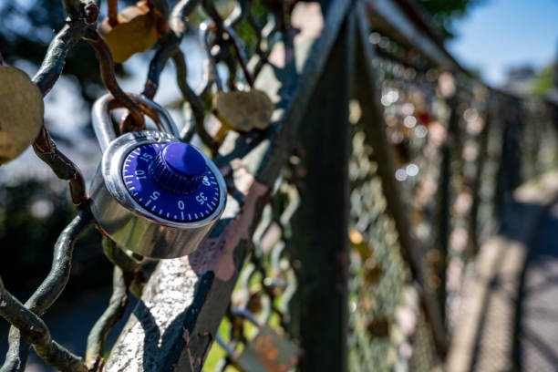 padlock stuck in metal fence in the city of Paris