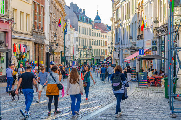 people tourists walking down pedestrian shopping street with many shops, stores, medieval houses and buildings in old town Brussels city historical center Brussels, Belgium, July 6, 2023: people tourists walking down pedestrian shopping street with many shops, stores, medieval houses and buildings in old town Brussels city historical center houses in brussels stock pictures, royalty-free photos & images