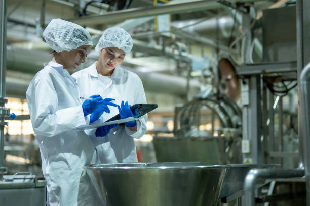 istock Two scientists wearing protective gear and gloves using a digital tablet in an industrial laboratory environment. 2162728315