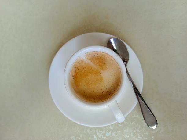istock A cup of warm latte coffee on a white table 2162730722