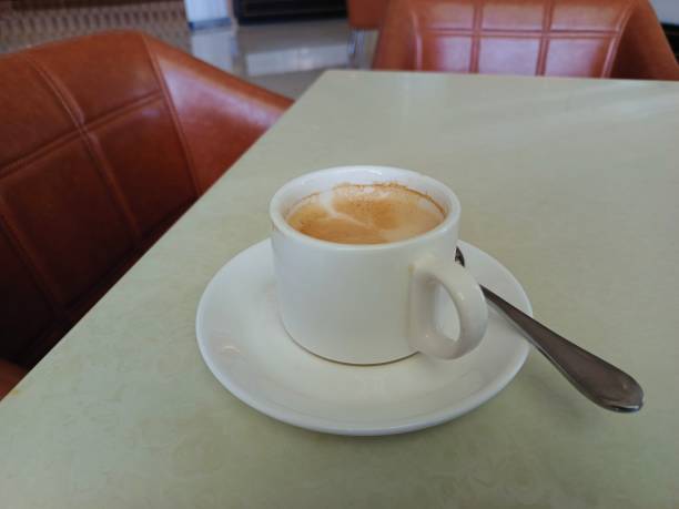 istock A cup of warm latte coffee on a white table 2162730728
