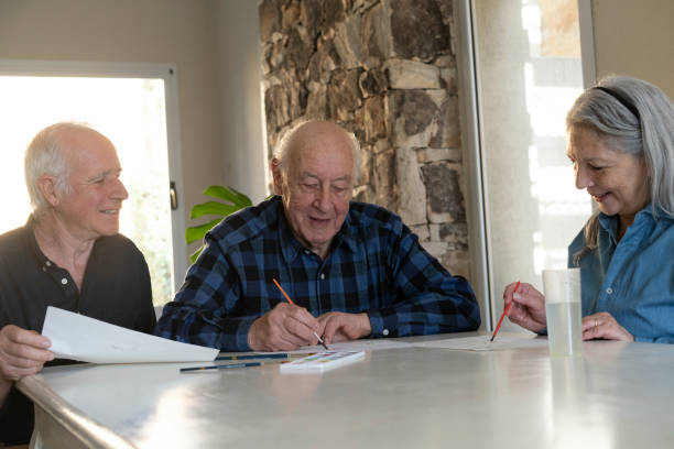 istock Community member helping mature couple going through paperwork 2162731871