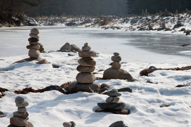 istock stone stacks at the frozen riverside 2162732260
