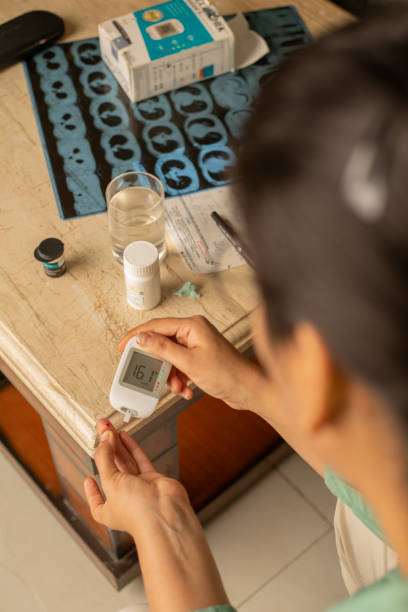 istock Woman with glucometer checking blood sugar level at home 2162738214