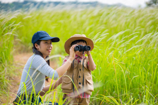 istock Mother teaching son Use binoculars They go hiking 2162738270