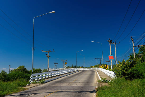 istock Road bridge against blue sky surrounding by tropical forest 2162739245