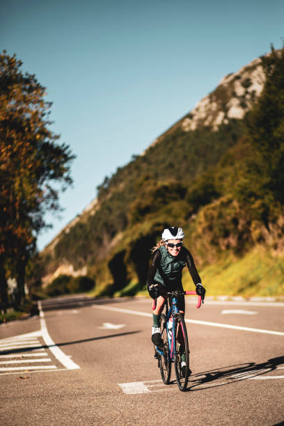 istock Woman cyclist training on the road 2162748218