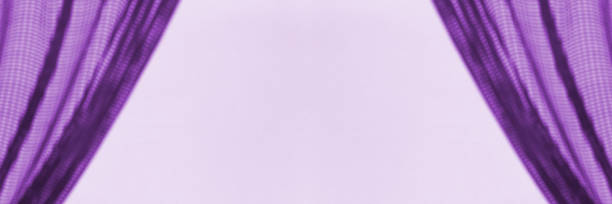 istock A frame with abstract silhouettes of shadows from curtains on a lilac  background falling on the wall with a copy space 2162748773
