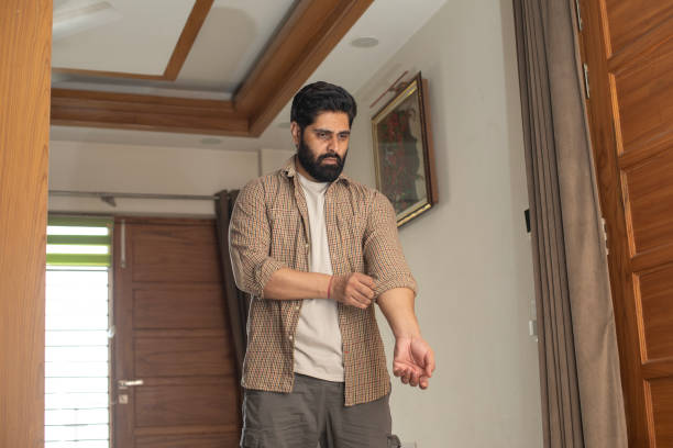 istock Bearded man wearing shirt while standing at home 2162749011