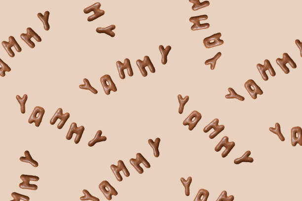 Sweet composition with the word Yammy on a beige background. Alphabet biscuits on a pastel background, top view, copy space