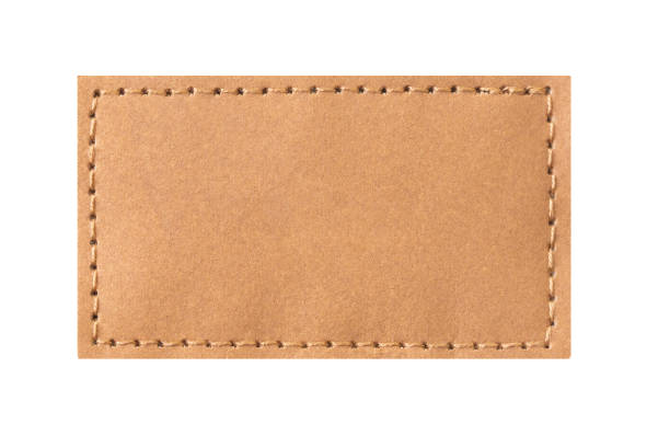 Fabric patch isolated. Perforated leather frame. Brown thread sew.