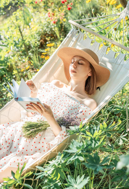istock Young woman relaxing in a hammock outdoors in back yard 2162752374