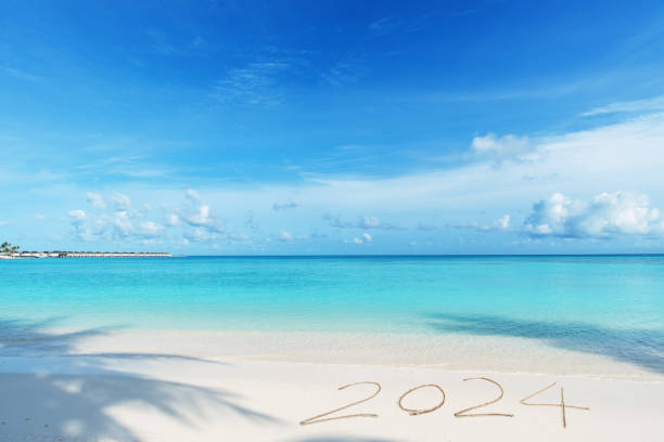 istock 2024 year written on topical paradise beach 2162753846
