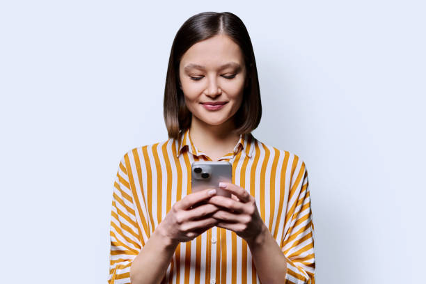istock Young business woman using smartphone on white background 2162754779