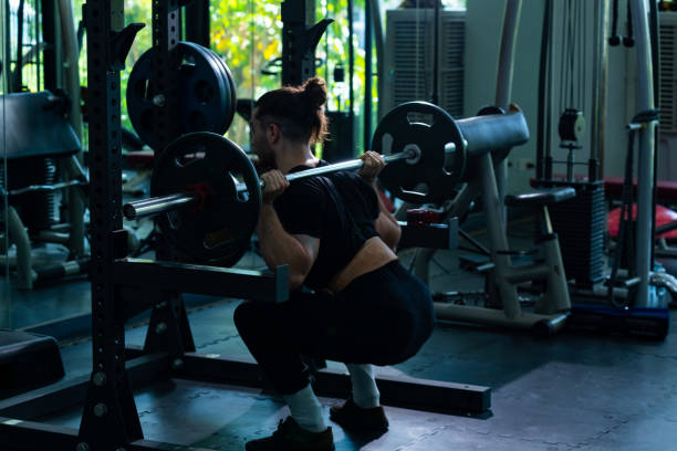 istock Caucasian man do weight training lifting barbell  at gym 2162756053