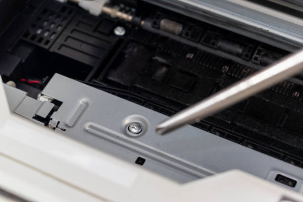 istock Turning a screw on a machine part with a screwdriver 2162756351