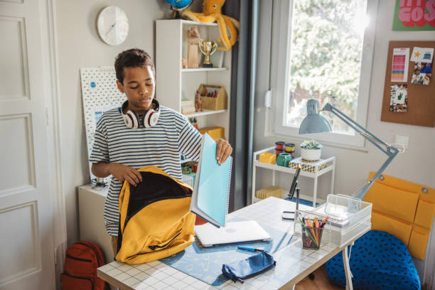 istock Teenage boy packing for school 2162757422
