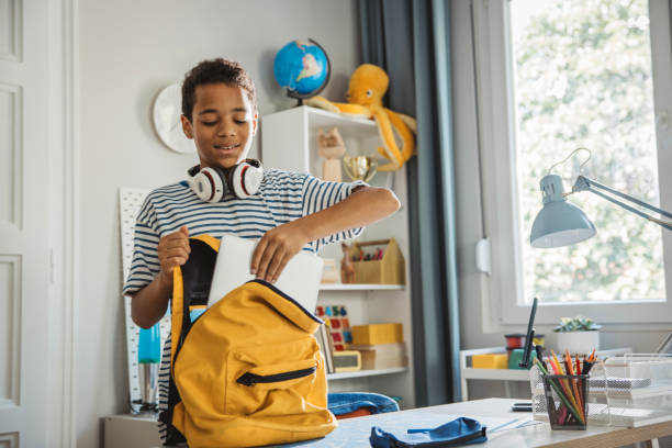 istock Teenage boy packing for school 2162757426