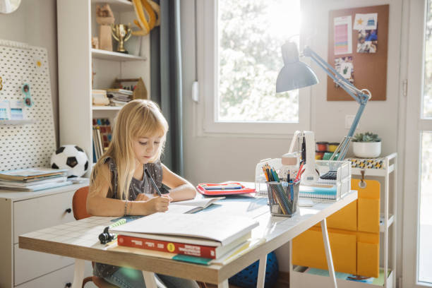 Schoolgirl studying at home