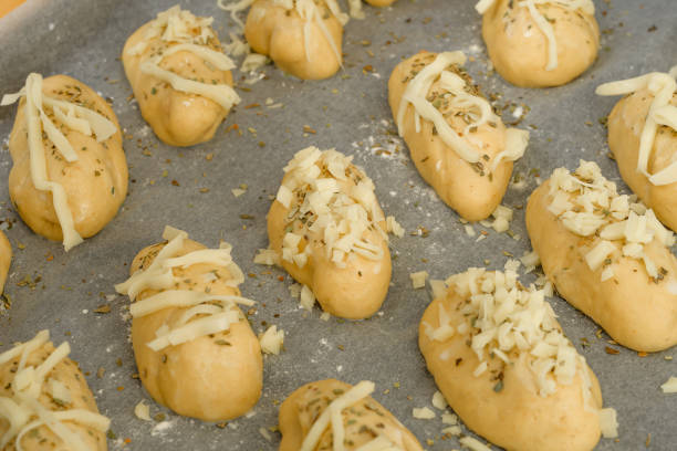 istock Wheat rolls with yellow cheese rising on a baking tray before baking 2162759661