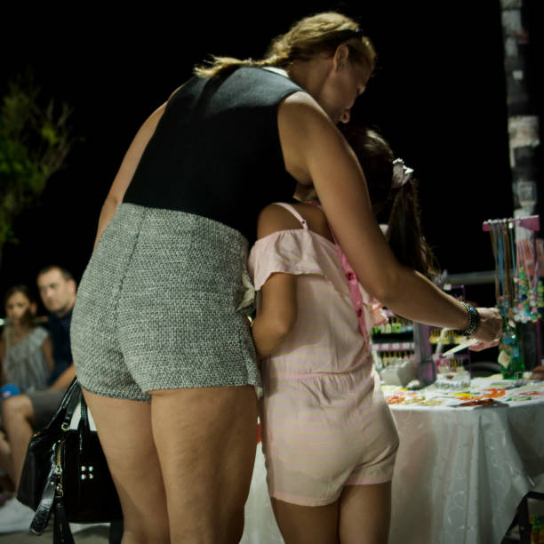Igalo Montenegro 6 July 2024: mother with daughter shopping at night