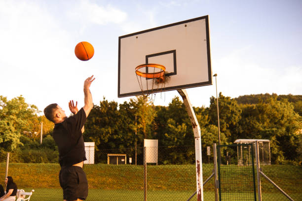 istock Young man playing basketball at sunset 2162760747