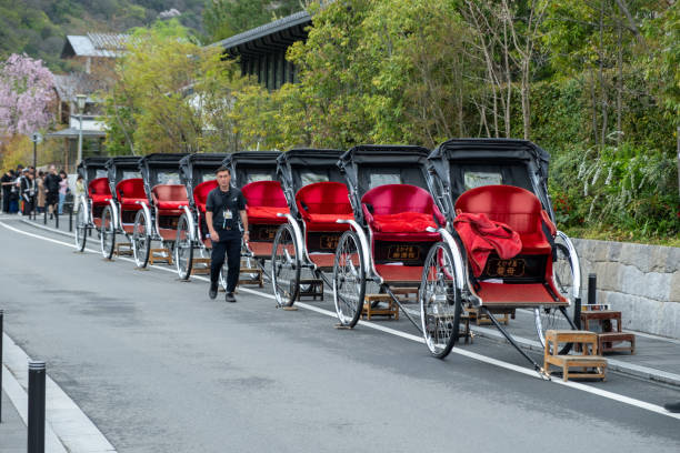Kyoto Japan. April 08, 2024. Traditional red hand pulled rickshaw parked in a row on Uji Bridge over Uji river.