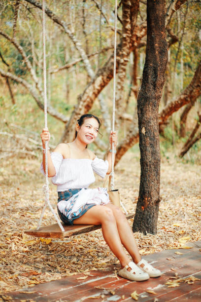 istock woman on swing 2162762681