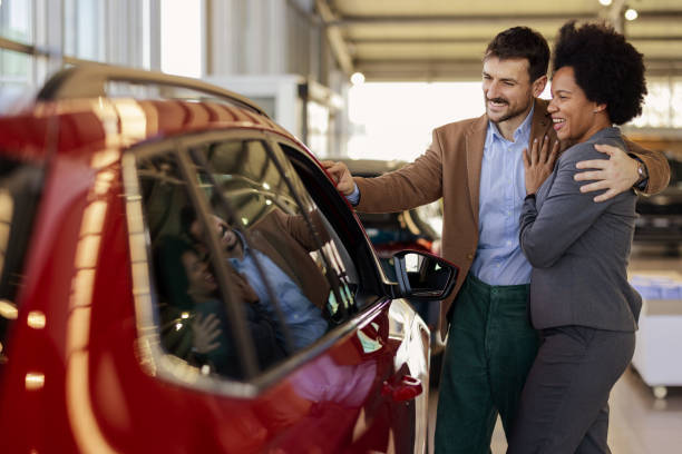istock Mixed Race Spouses Buying New Car 2162767358