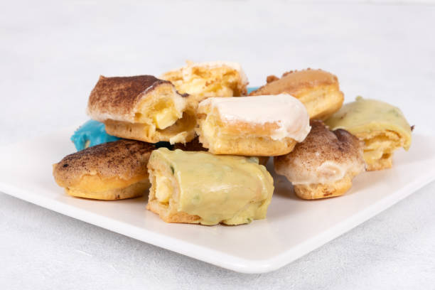 Assorted Eclairs in Vibrant Colors: A Delightful and Colorful Pastry Display