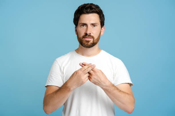 istock Young bearded man showing sign language standing in studio 2162776497