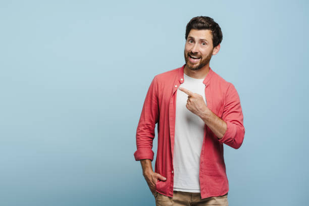 istock Smiling bearded Caucasian man pointing to copy space over blue background 2162776519
