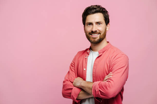 istock Smiling bearded young man holding arms crossed, posing in studio, looking at camera 2162776548