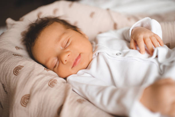 istock Sleeping infant baby in bed close up 2162779514