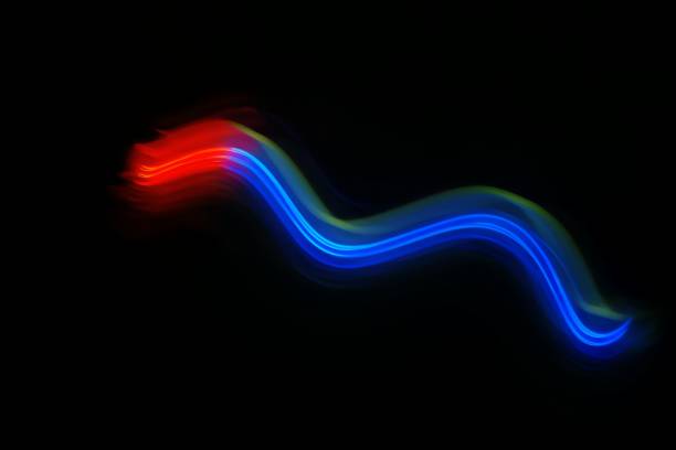 Blurred neon light. Overlay of colored light. Disco lighting. Soft texture of unfocused purple red blue ultraviolet rays on dark abstract empty space background