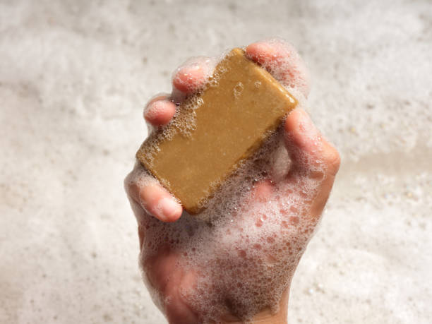 istock Man holds foaming soap in his hand. 2162780968