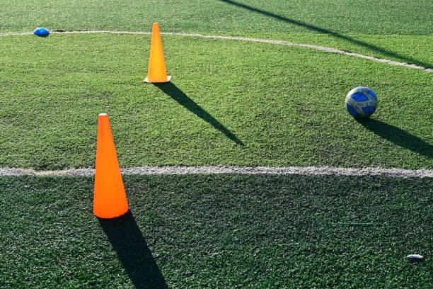 istock artificial green grass soccer field with orange training cones 2162781750