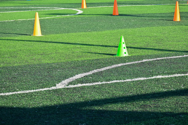istock artificial green grass soccer field with orange training cones 2162781755