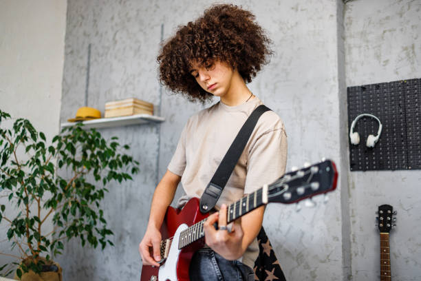 istock Young boy play electric guitar ah home 2162782933