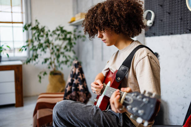 istock Young boy enjoys guitar sound 2162782954