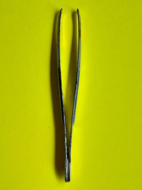 istock Eyebrow tweezers with yellow background 2162783550