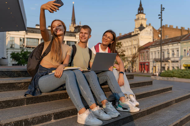 istock Friends capture fun moments seated on campus steps. 2162783731