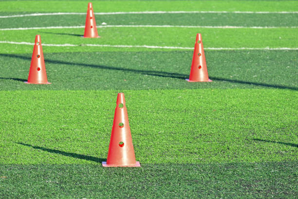 istock artificial green grass soccer field with orange training cones 2162783777