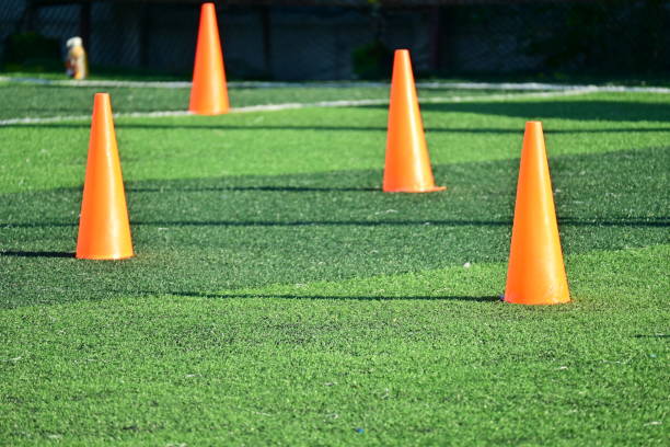 istock artificial green grass soccer field with orange training cones 2162784673