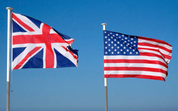 istock US and UK national flags against the blue sky 2162784696