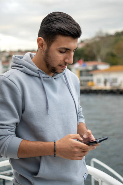 istock Handsome boy using mobile phone outdoors 2162785973
