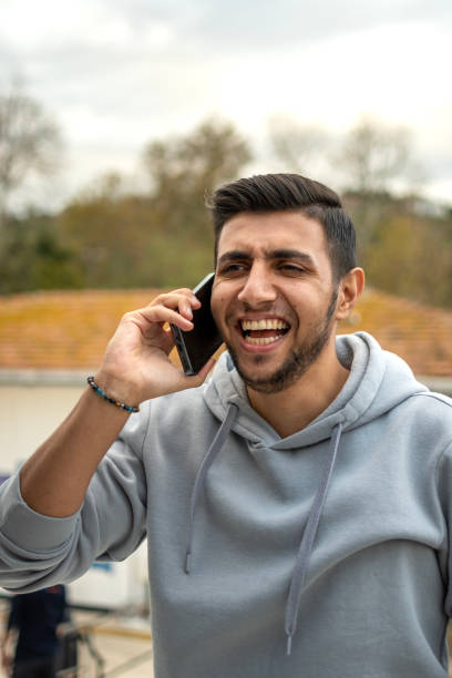 istock Handsome boy using mobile phone outdoorse 2162786071