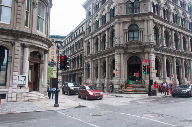 Montreal, Canada.  July 5, 2019. The unique architecture and the british empire building lining a street in old montreal in quebec canada on an overcast day.