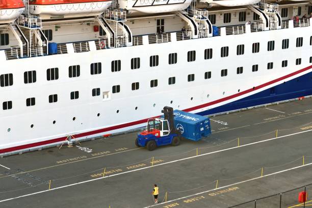 Vancouver, Canada - 4th July 2023:Forklift truck moving a waster container into place for the cruise ship to use