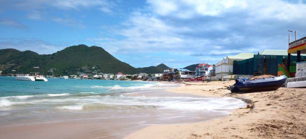 Orient Bay, St Maarten - 2nd February 2024:The curved sea front of Orient Bay, with beached dinghies